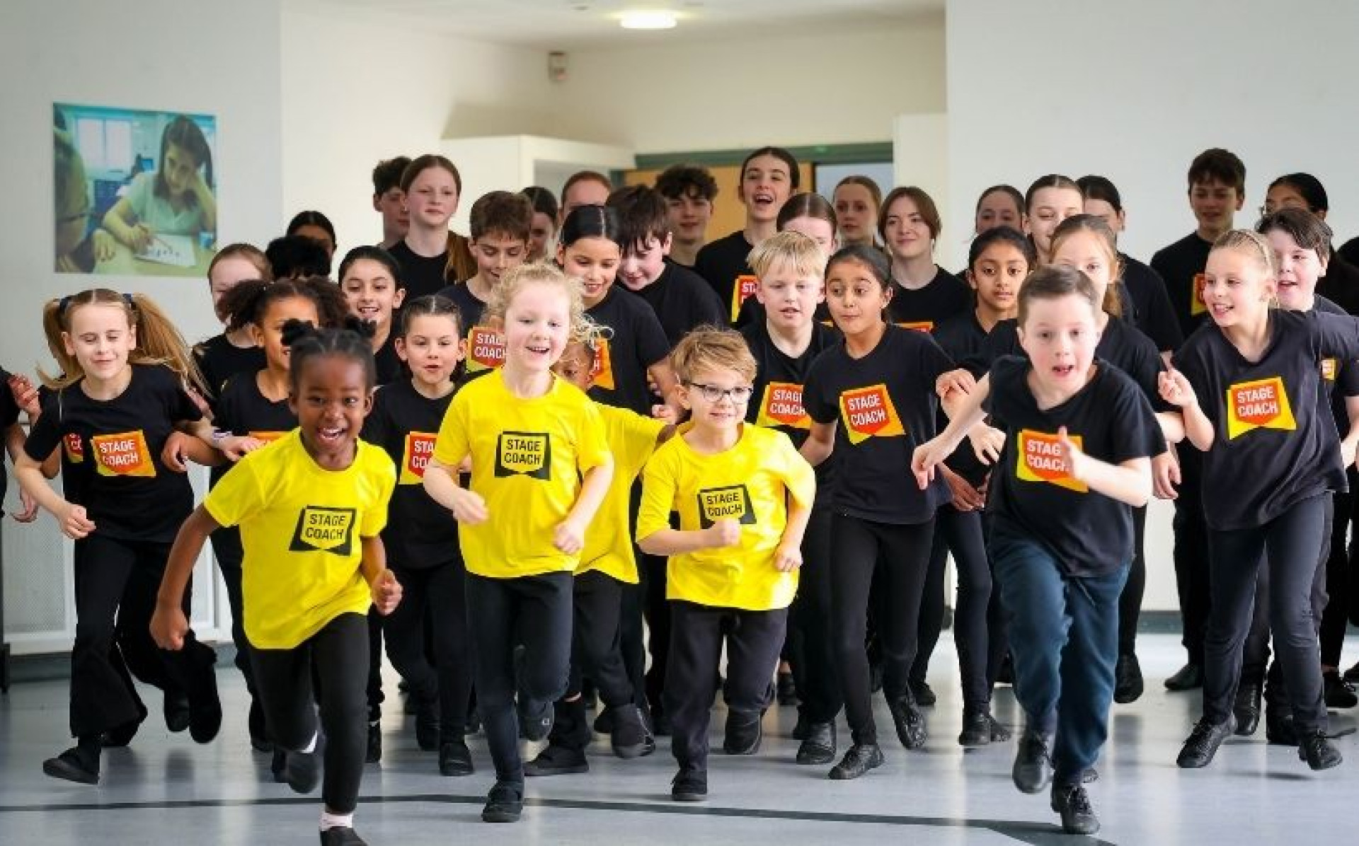 Stagecoach teacher supporting students in a supervised learning environment, reflecting Stagecoach's commitment to child safeguarding and student wellbeing.