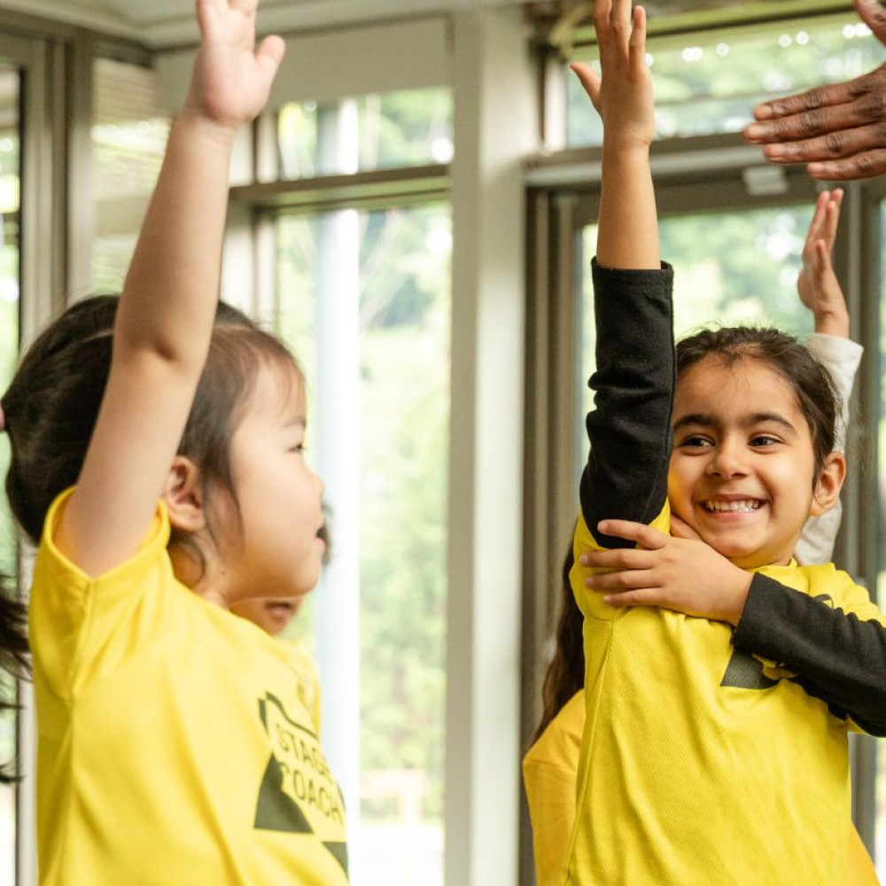 Child making friends in a performing arts class