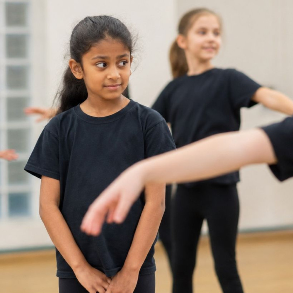 Child preparing to join other children in a performing arts class