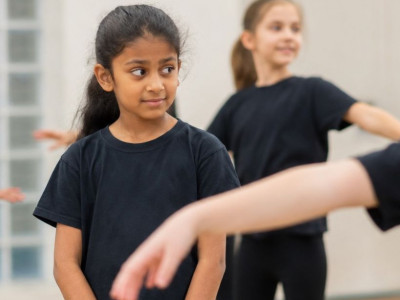Child preparing to join other children in a performing arts class