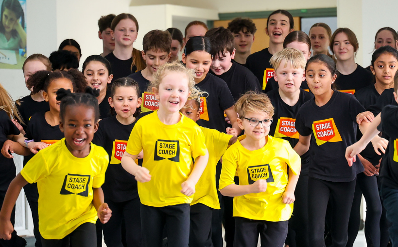 Stagecoach students of different ages taking part together in a performing arts class
